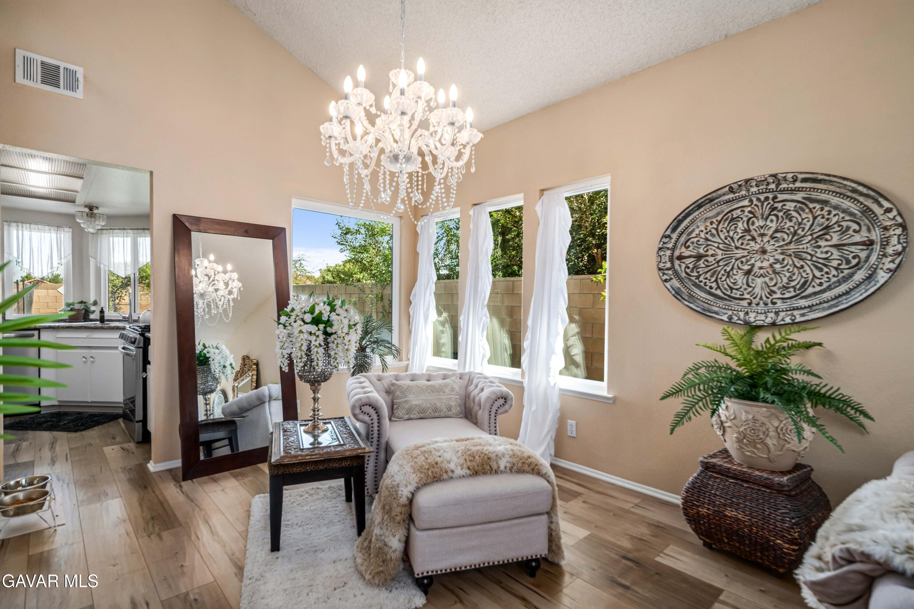 4535 Talento Way Palmdale, CA 93551 - Photo 9 of 43 a living room with furniture and a chandelier
