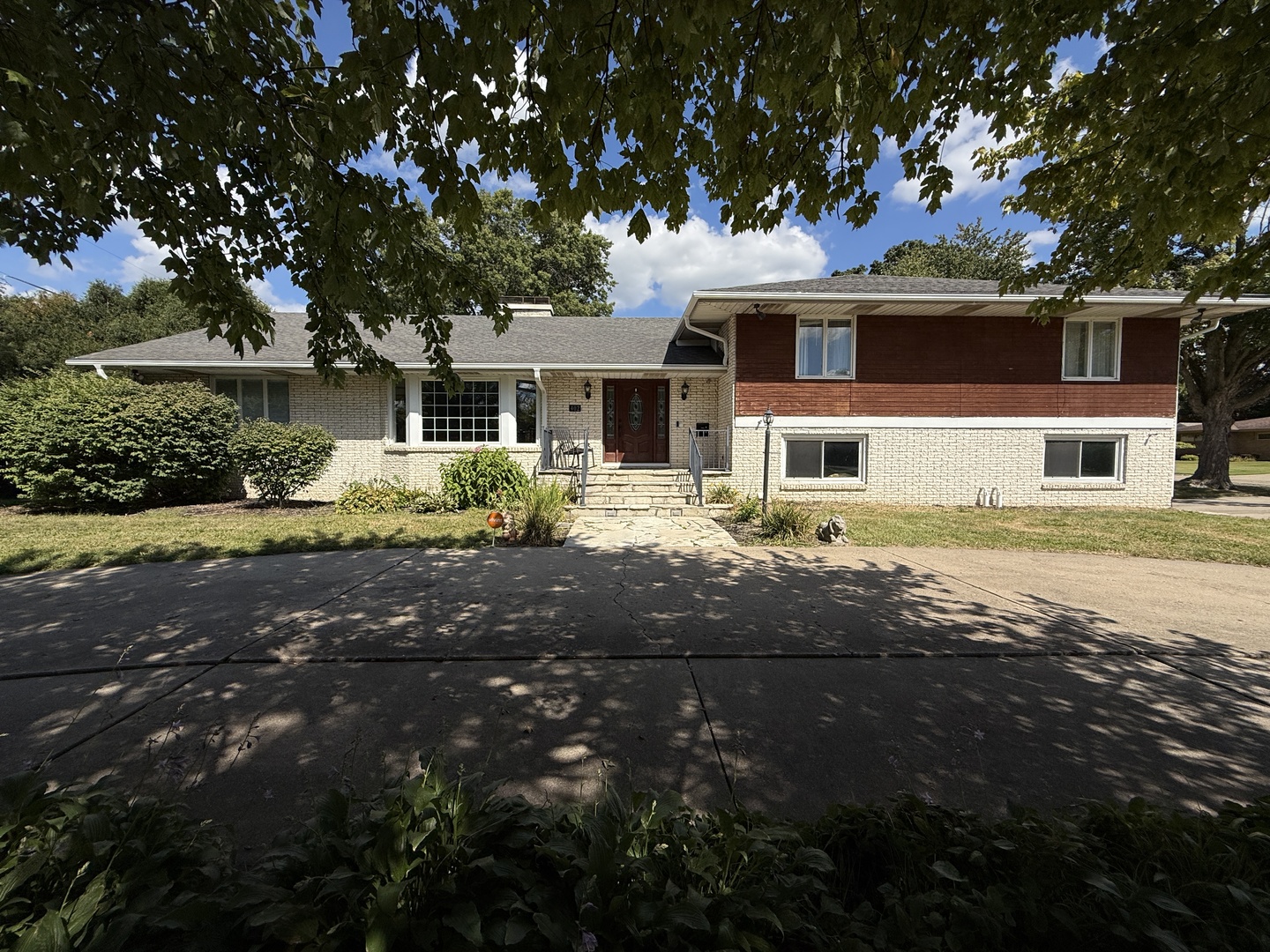 a front view of a house with a garden