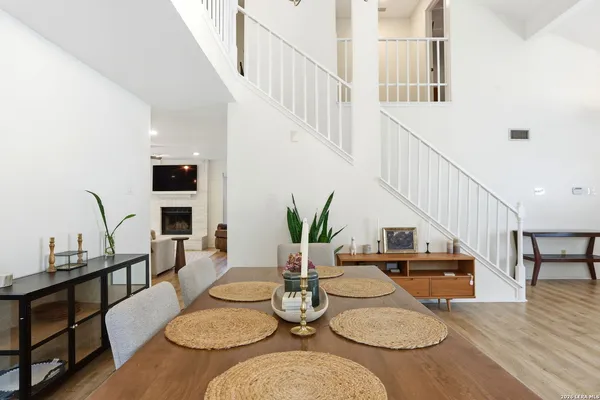 a dining room with furniture and wooden floor