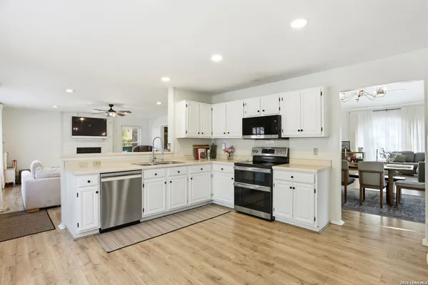 a kitchen with stove microwave and cabinets