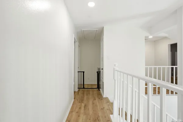 a view of a hallway with wooden floor