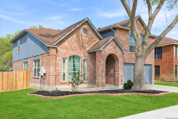 a front view of a house with a garden and plants