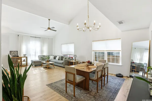 a living room with lots of furniture chandelier and a window