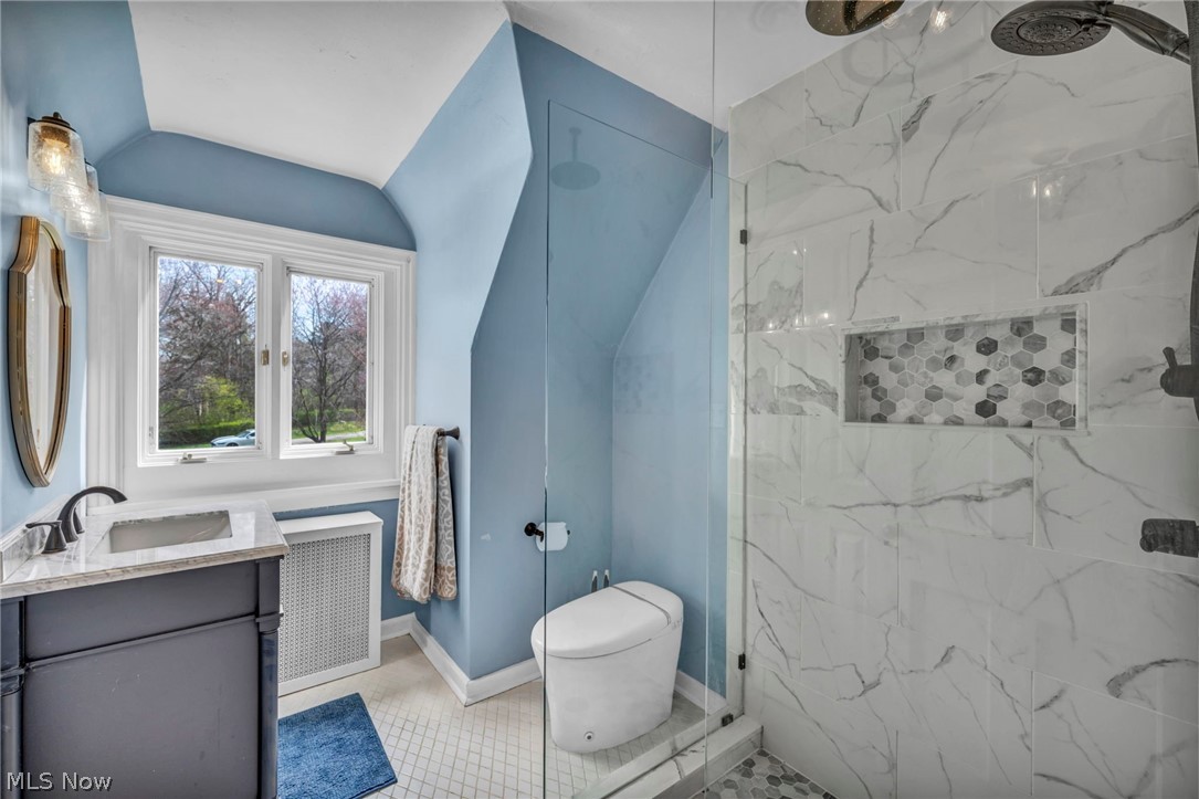 396 Overbrook Road Elyria, OH 44035 - Photo 35 of 50 Bathroom with toilet, radiator heating unit, tile floors, tiled shower, and vanity