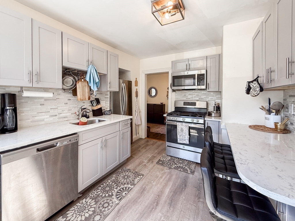 a kitchen with stainless steel appliances granite countertop a stove and a sink