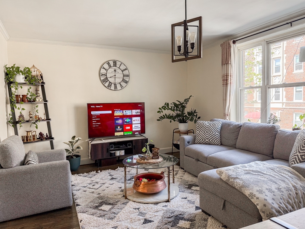 84 Strathmore Road, Unit 4 Boston, MA 02135 - Photo 4 of 14 a living room with furniture and a flat screen tv