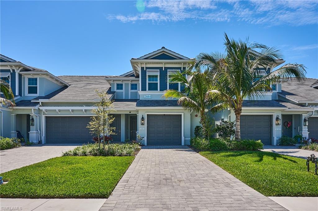 2664 Seychelles Circle, Unit 2402 Naples, FL 34112 - Photo 1 of 30 front view of house with a yard