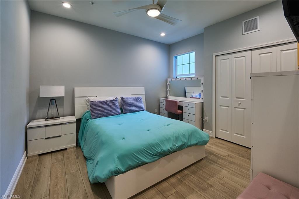 2664 Seychelles Circle, Unit 2402 Naples, FL 34112 - Photo 13 of 30 a bedroom with a large bed and furniture