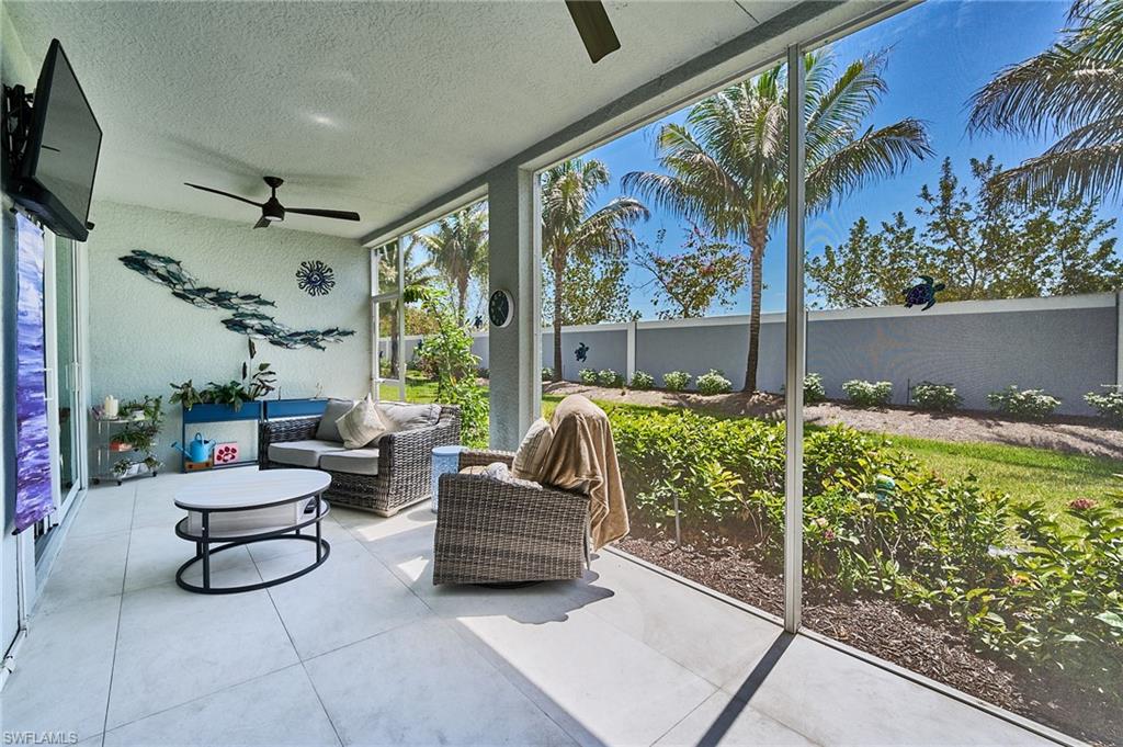 2664 Seychelles Circle, Unit 2402 Naples, FL 34112 - Photo 16 of 30 a living room with patio furniture and a potted plant
