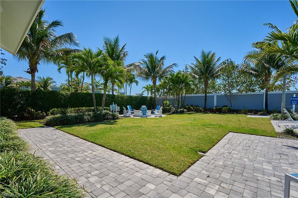 2664 Seychelles Circle, Unit 2402 Naples, FL 34112 - Photo 23 of 30 a view of a backyard with palm trees