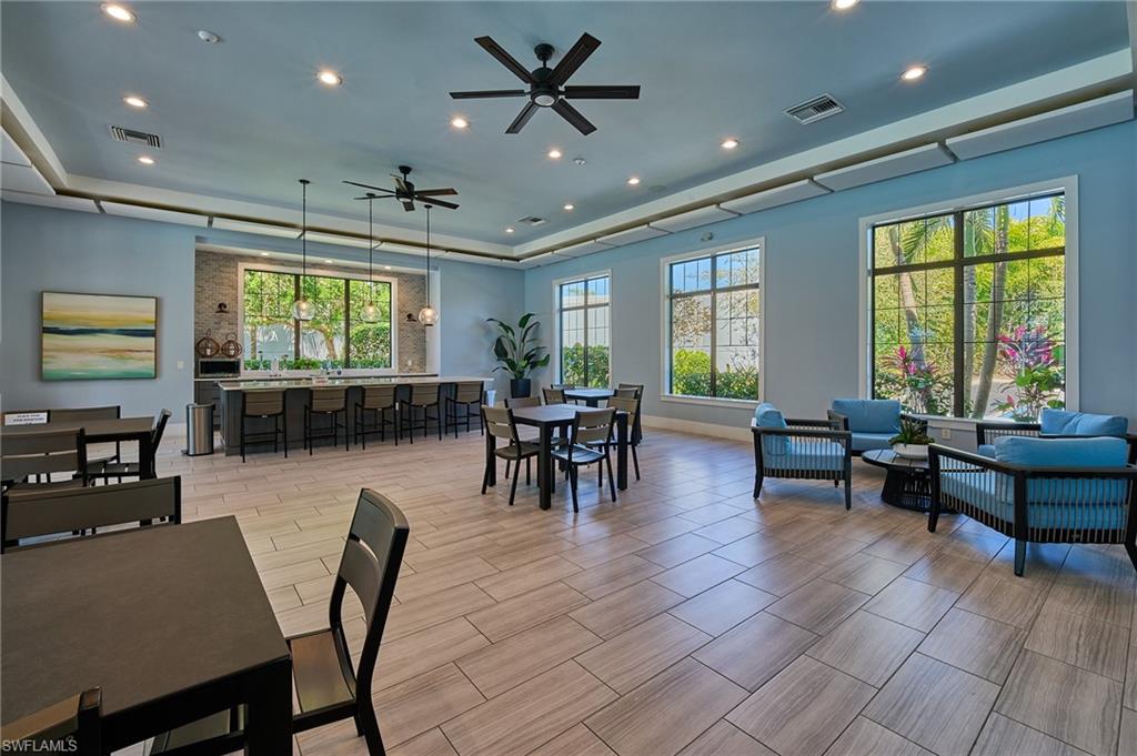 2664 Seychelles Circle, Unit 2402 Naples, FL 34112 - Photo 26 of 30 a living room with furniture and a large window