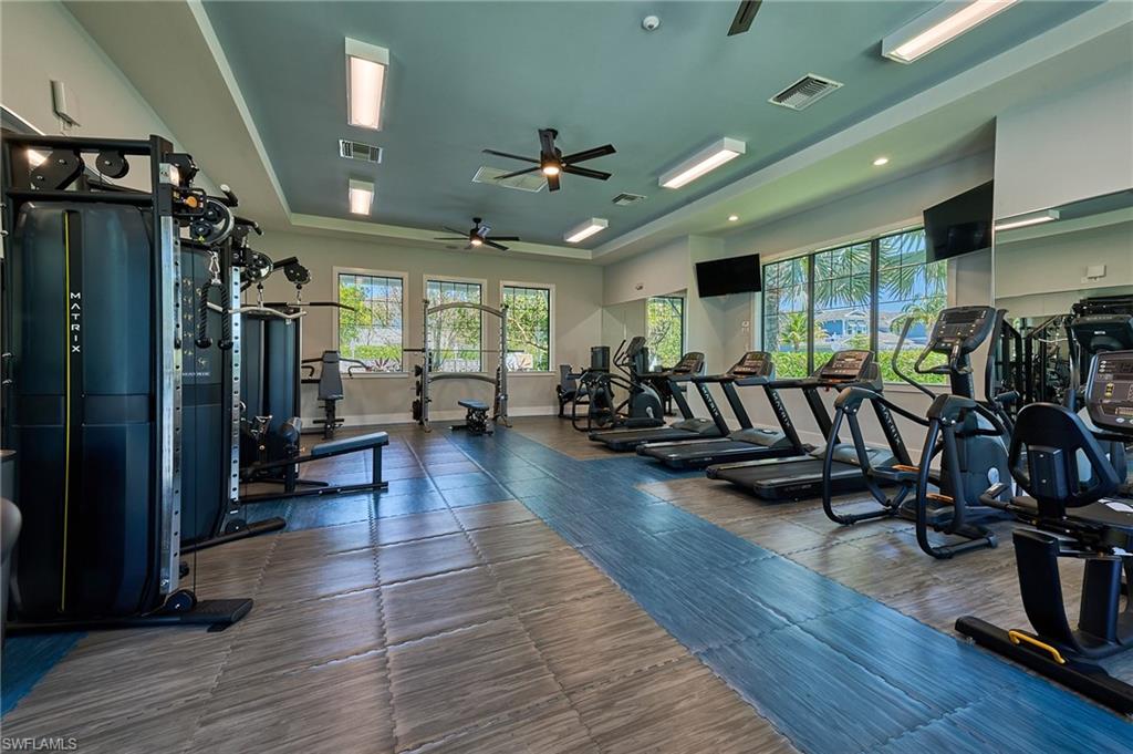 2664 Seychelles Circle, Unit 2402 Naples, FL 34112 - Photo 28 of 30 a view of a room with lots of wooden furniture wooden floor and windows