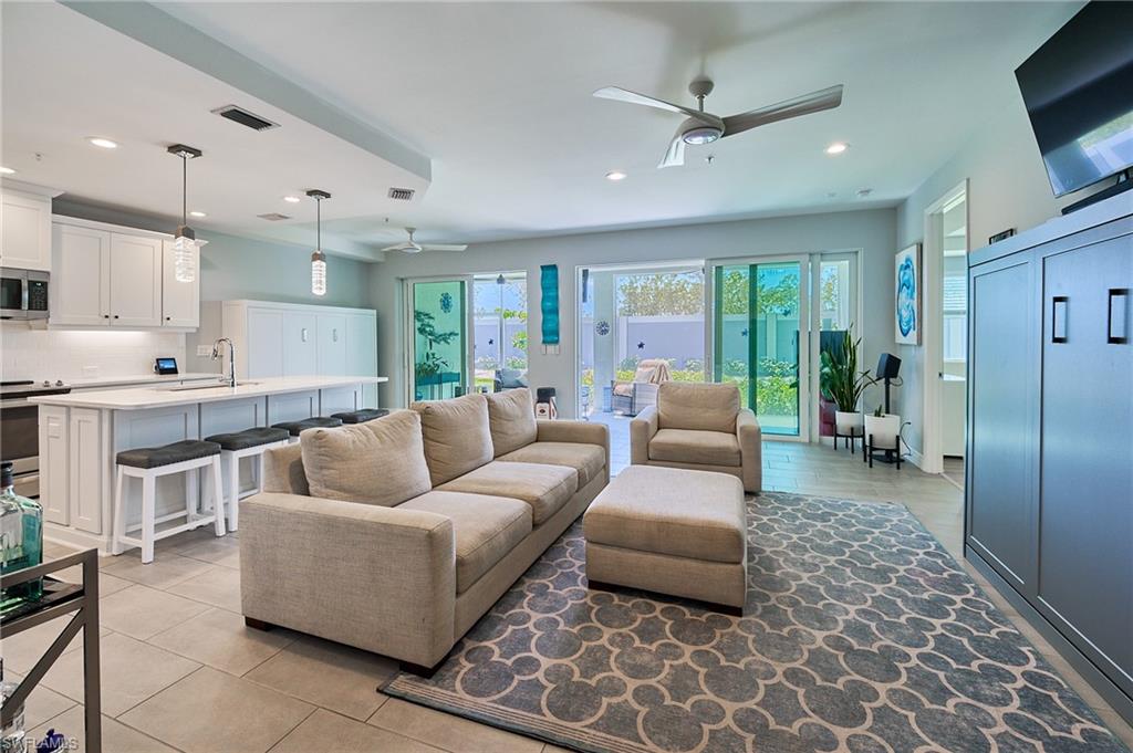 2664 Seychelles Circle, Unit 2402 Naples, FL 34112 - Photo 5 of 30 a living room with furniture and a flat screen tv