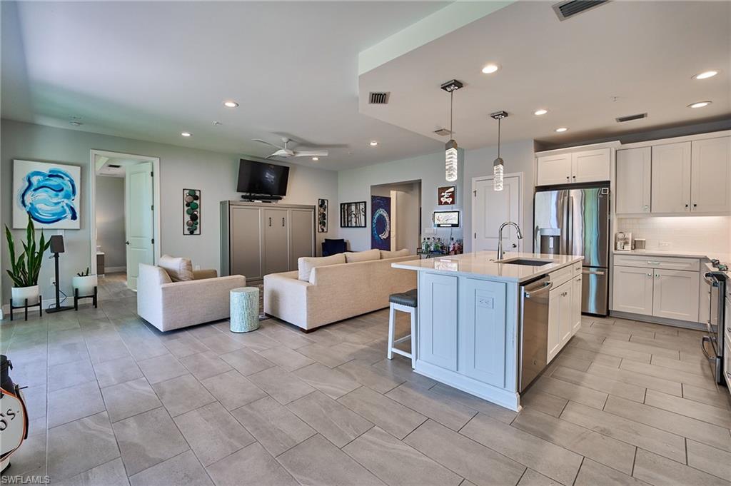 2664 Seychelles Circle, Unit 2402 Naples, FL 34112 - Photo 6 of 30 a large room with a large counter top furniture and kitchen view