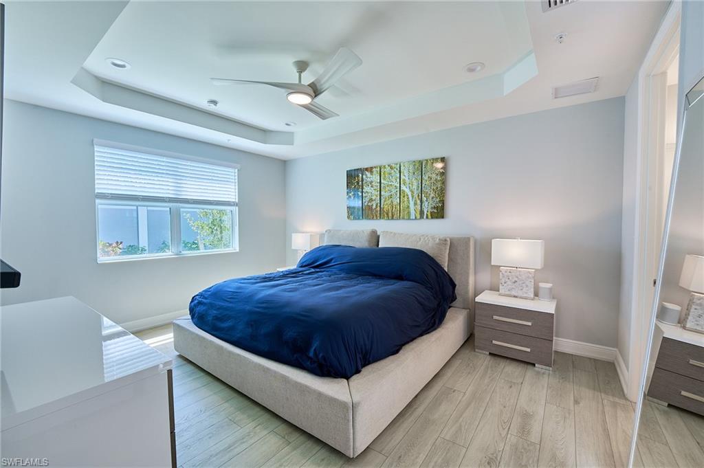 2664 Seychelles Circle, Unit 2402 Naples, FL 34112 - Photo 8 of 30 a spacious bedroom with a bed and a window