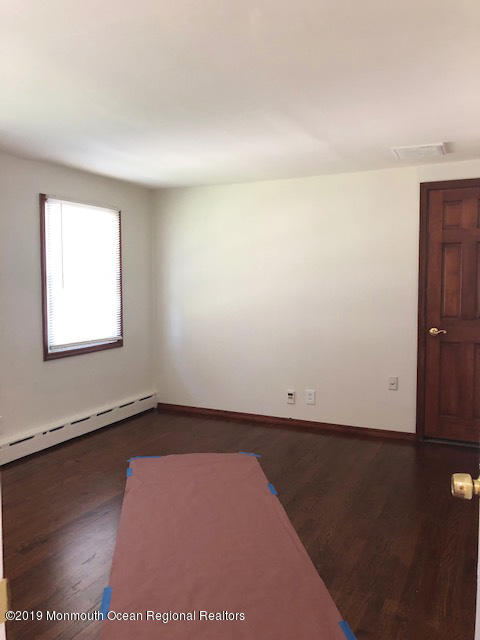 330 Eleanor Road Forked River, NJ 08731 - Photo 8 of 35 an empty room with wooden floor and windows