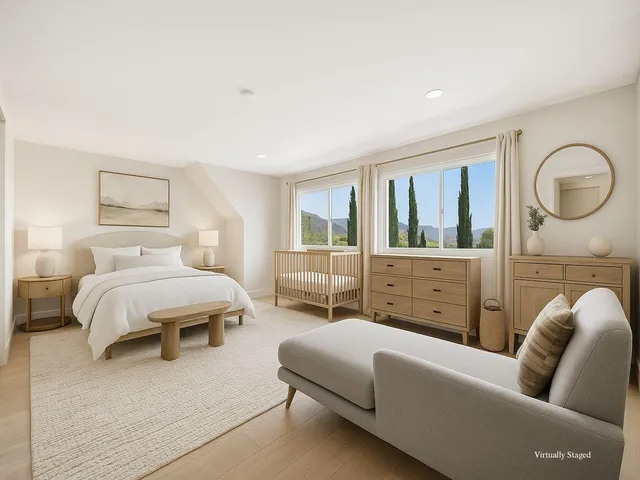 a dining room with wooden floor a chandelier a wooden table and chairs