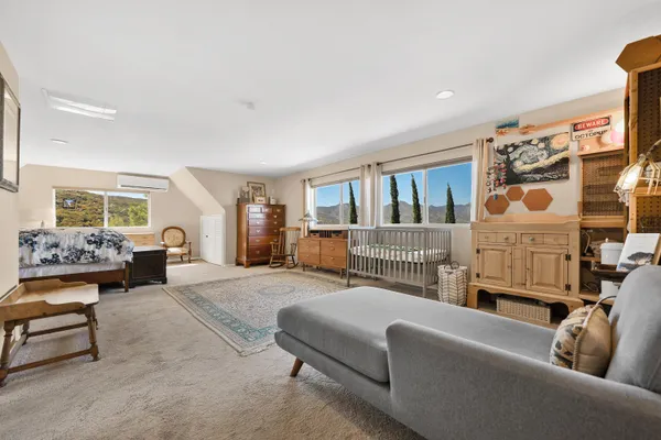 a bedroom with furniture and a window