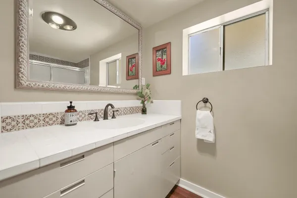 a spacious bathroom with a bathtub and a sink