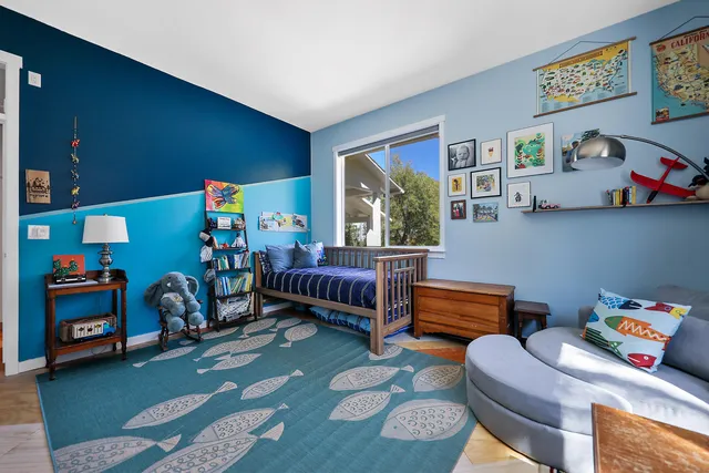 a bedroom with furniture and a window