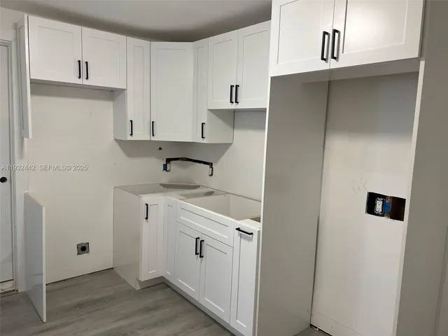 a kitchen with cabinets and stainless steel appliances