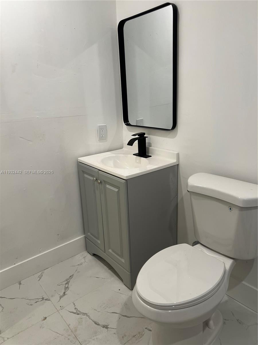 45 Northeast 60th Street Miami, FL 33137 - Photo 17 of 17 a bathroom with a toilet sink and mirror
