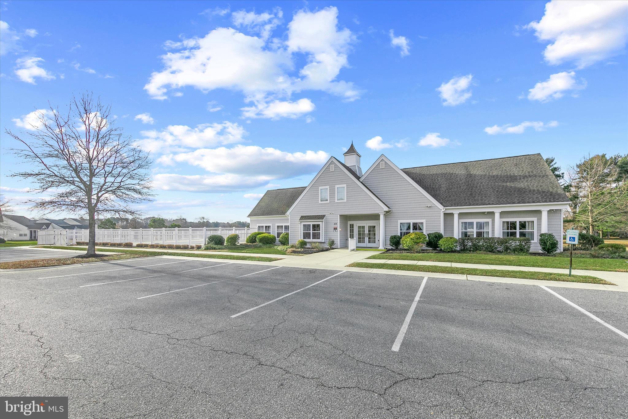 197 Intrepid Lane, Unit 1302 Berlin, MD 21811 - Photo 17 of 20 a front view of a house with a garden and trees