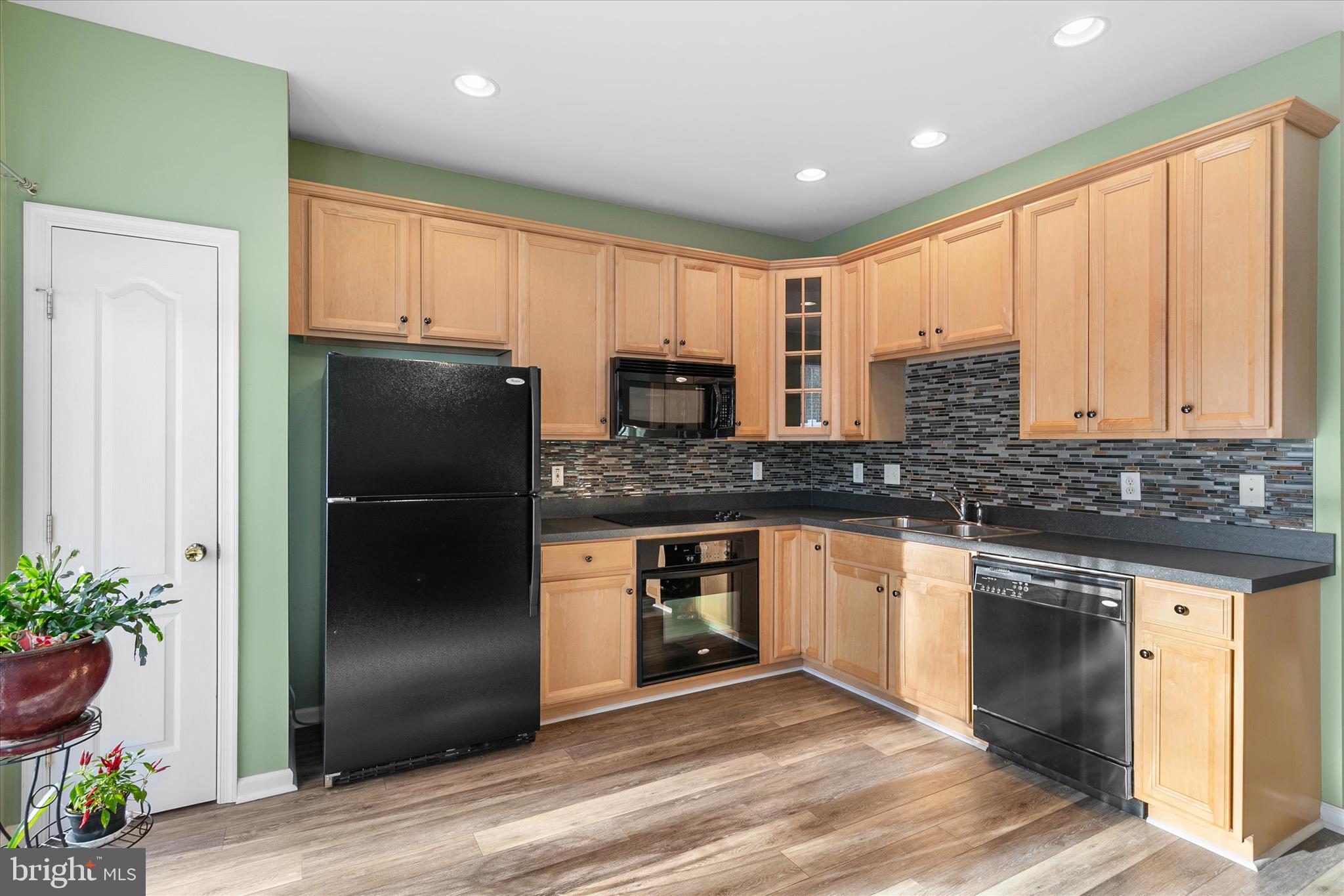 197 Intrepid Lane, Unit 1302 Berlin, MD 21811 - Photo 7 of 20 a kitchen with granite countertop stainless steel appliances a refrigerator a stove a sink and cabinets