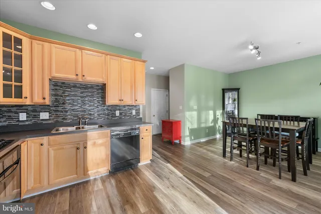 a kitchen with stainless steel appliances granite countertop a stove and cabinets