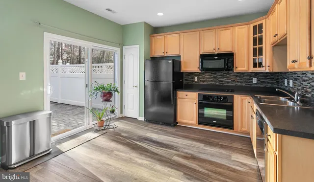 a kitchen with stainless steel appliances granite countertop a stove a refrigerator and a microwave