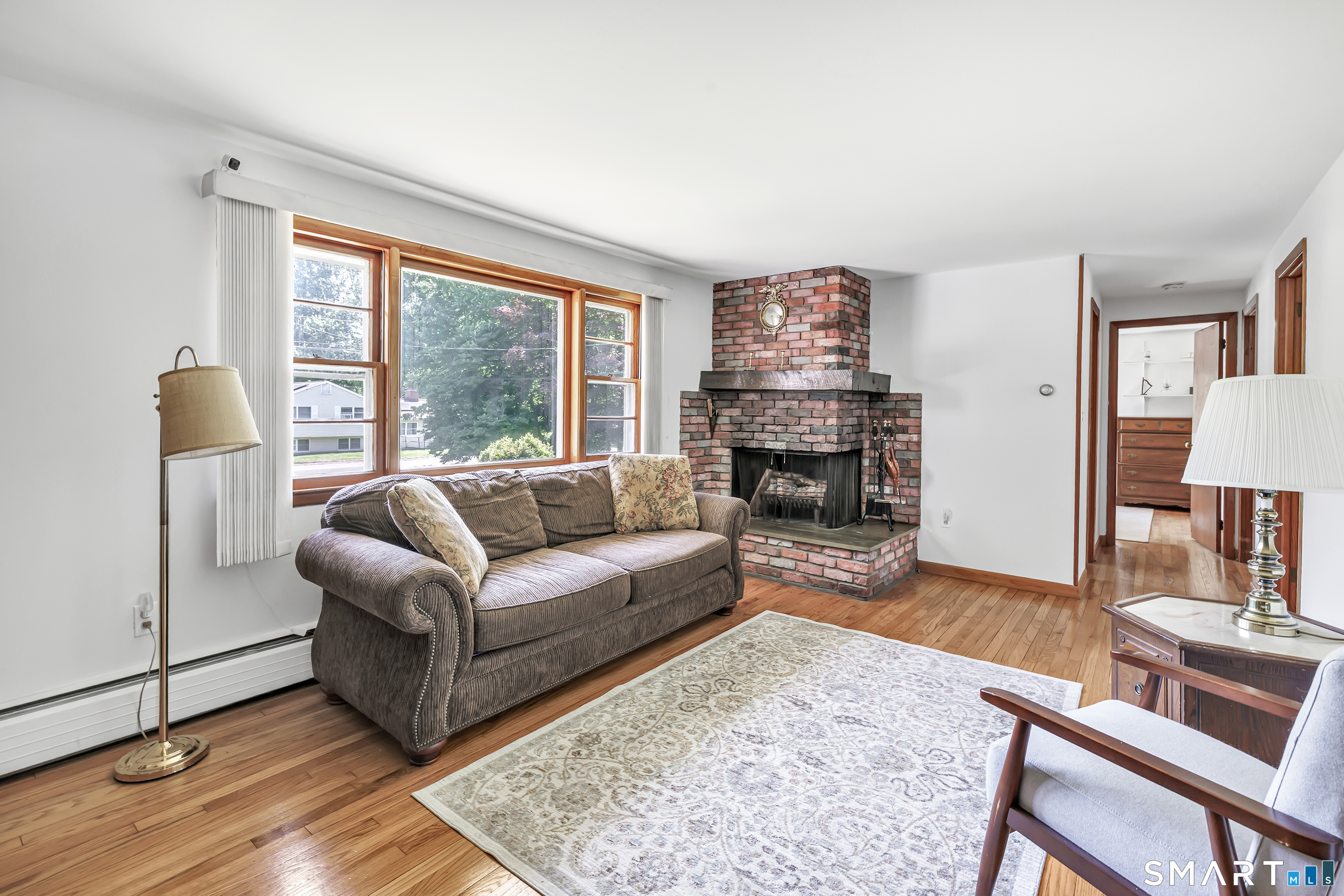 223 Wheeler Road Monroe, CT 06468 - Photo 6 of 35 a living room with furniture and a fireplace