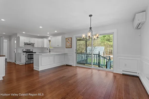 a view of a kitchen with furniture wooden floor and windows