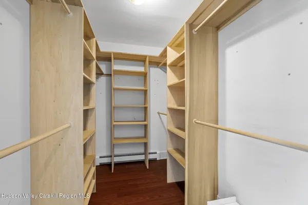 a view of walk in closet with empty racks