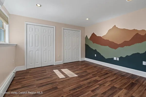 a view of a room with wooden floor and closet