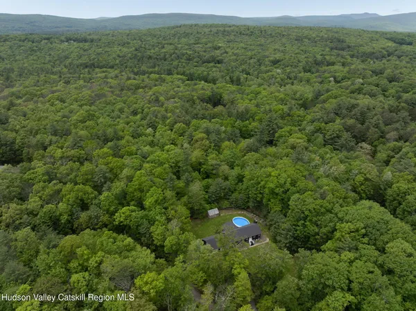 a view of a field of grass and trees