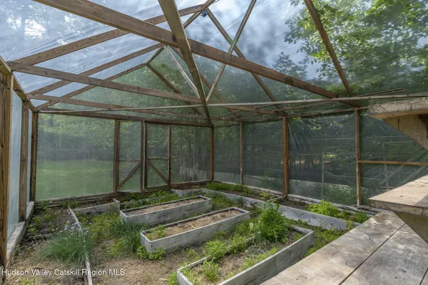 a backyard of a house with outdoor seating and barbeque oven
