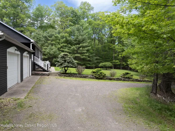 a view of a yard with plants and a trees