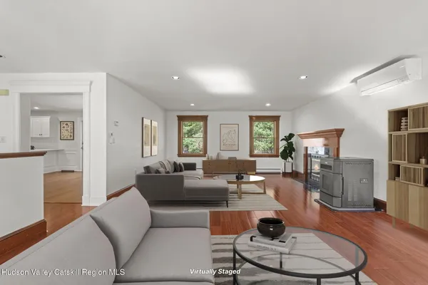 a living room with furniture and a wooden floor