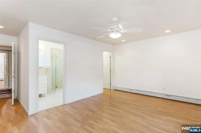a bathroom with a shower sink vanity and toilet