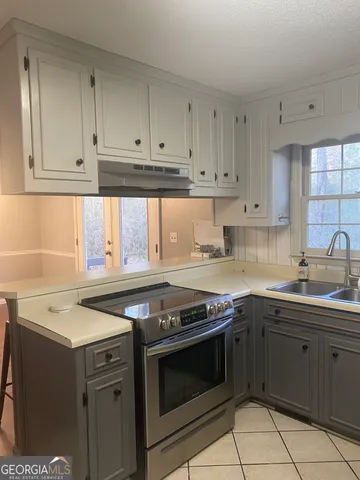 a kitchen with stainless steel appliances granite countertop a sink stove and cabinets