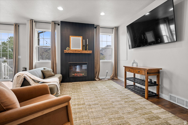 3359 Eurasian Crane Road Clinton, UT 84015 - Photo 13 of 71 Living room featuring a fireplace, wood finished floors, and recessed lighting