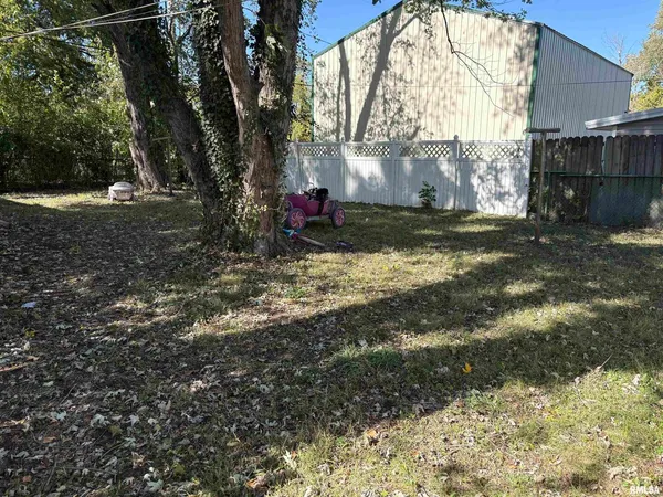 a view of a yard with large trees
