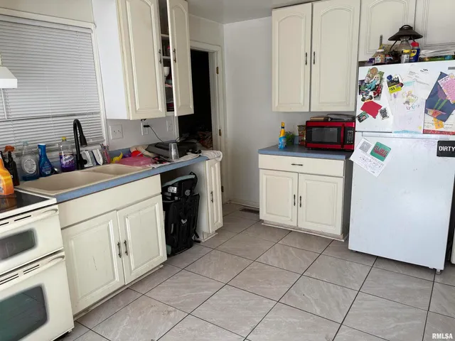 a kitchen with a cabinets and white appliances