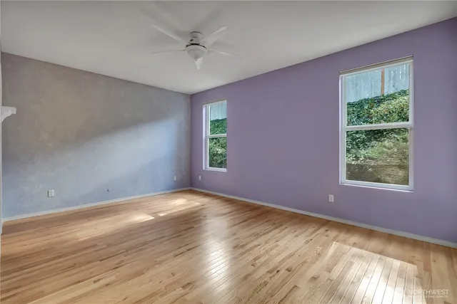 a view of an empty room with closet and a window