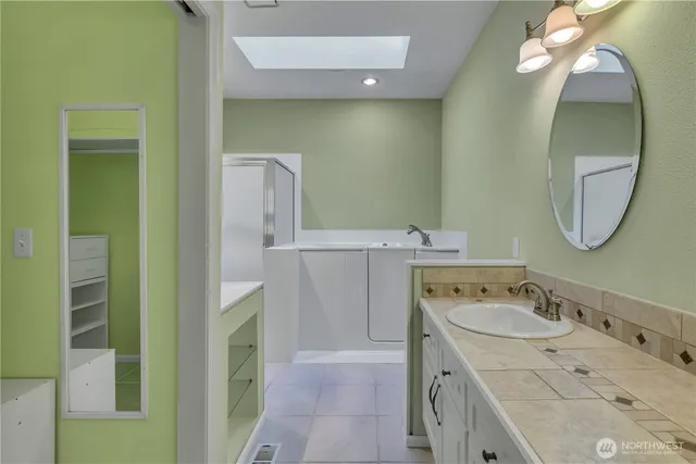 a bathroom with a double vanity sink and a mirror