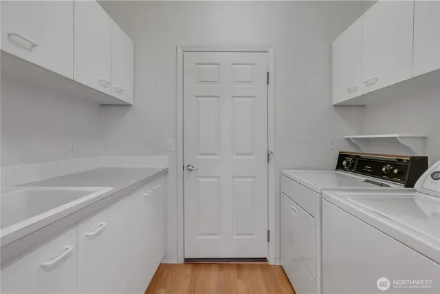 a view of a backyard of plants and wooden fence