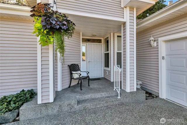a view of a house with a backyard and a tree