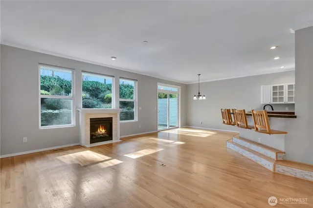 a view of an empty room with a fireplace and a window