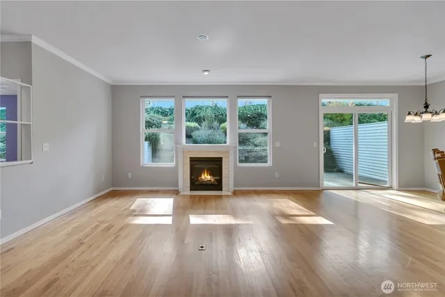 a view of a livingroom with wooden floor and a ceiling fan