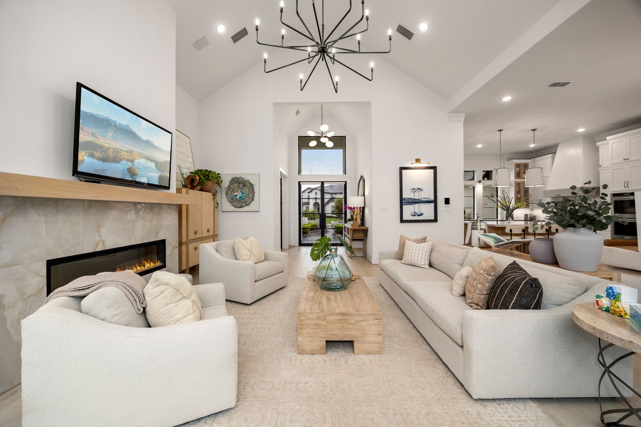 27903 Indigo Ridge Drive Fulshear, TX 77441 - Photo 8 of 50 Vaulted ceilings, designer lighting, and expansive windows create a bright and inviting gathering space.